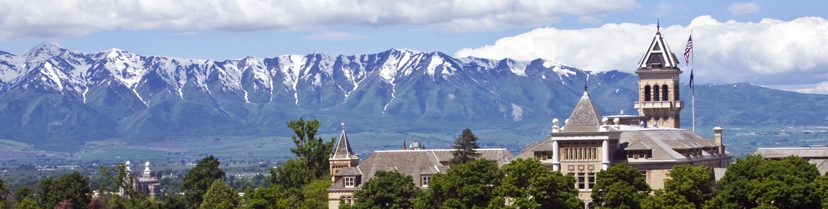 Crests of Wellsville Mountains with USU’s Old Main in foreground.